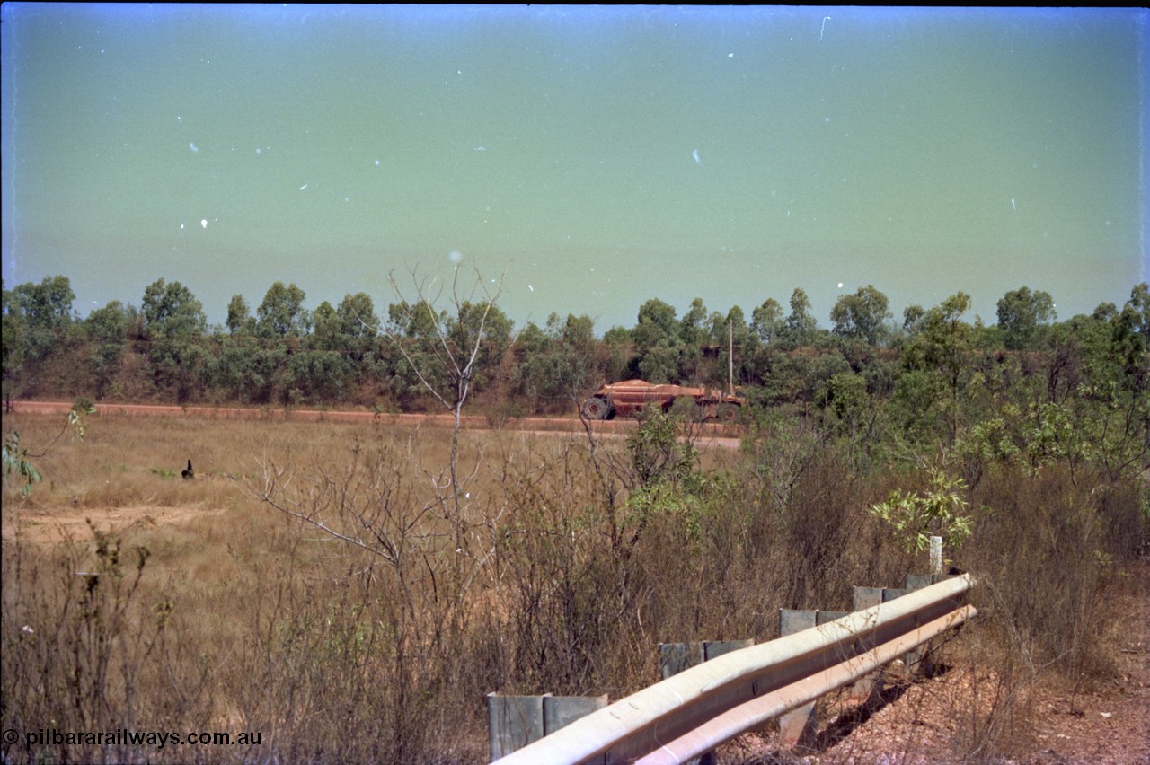 212-03
Weipa, Lorim Point, view of articulated haulpak on haul road from overbridge.
