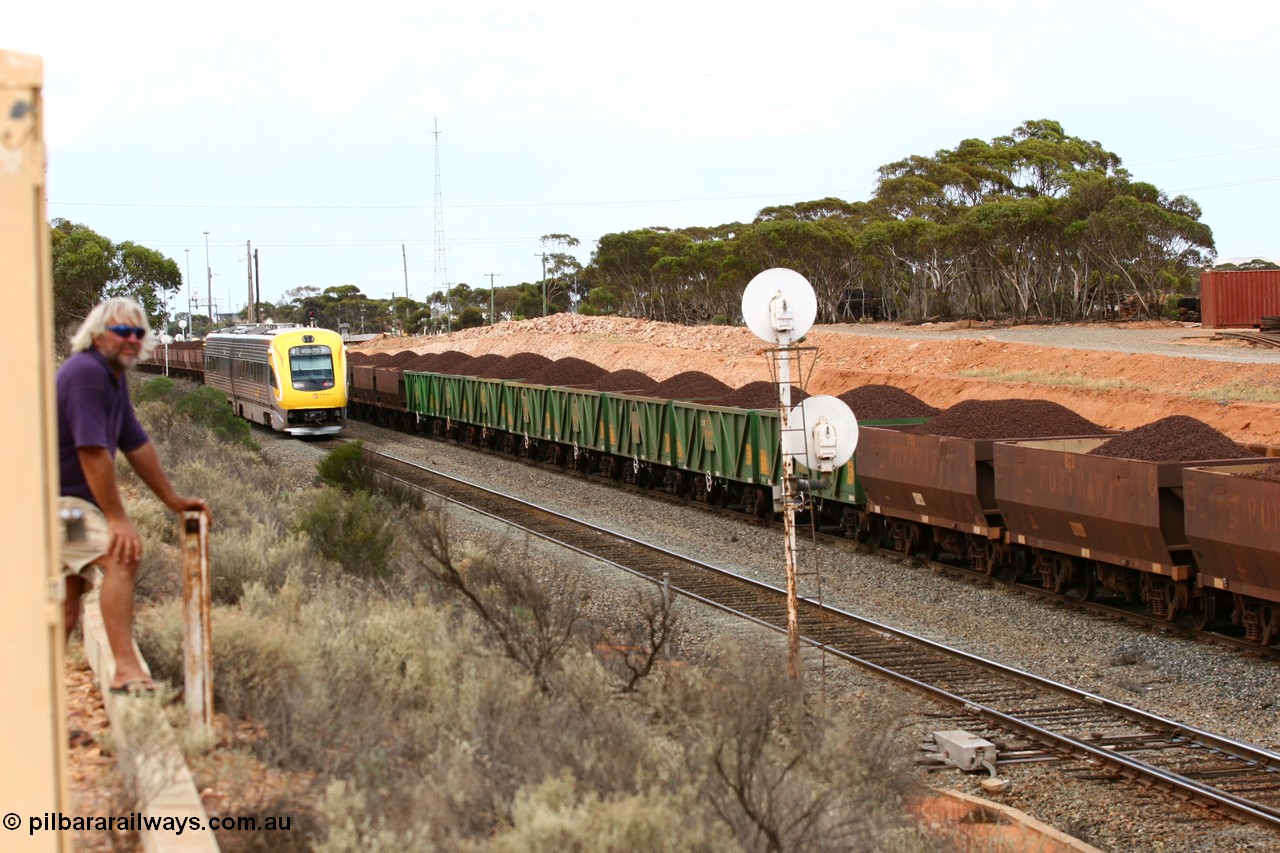 060116 2683
AOPY and WOE iron ore waggons loaded with lump ore depart West Kalgoorlie for Esperance as the Prospector awaits entry to continue to Kalgoorlie, while Pope Searle takes in the action, West Kalgoorlie 16th January 2006.
Keywords: AOPY-type;WOE-type;