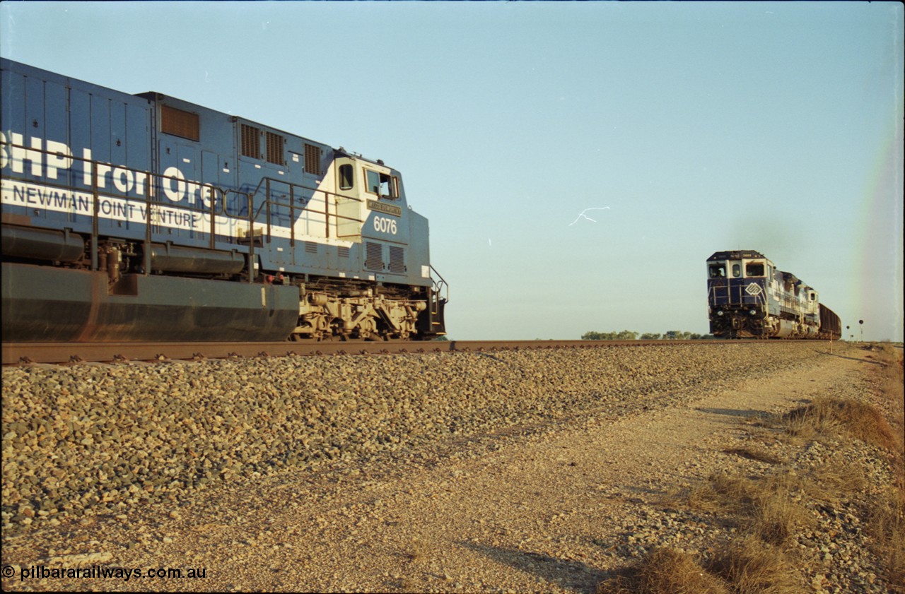 203-13
Bing Siding, a loaded BHP Iron Ore train with a pair of CM40-8M units on the lead are on the mainline as the cross the empty train behind General Electric AC6000 unit 6076 'Mt Goldsworthy' serial 51068.
Keywords: 6076;GE;AC6000;51068;