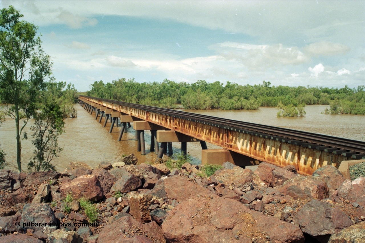 218-03
De Grey River Bridge, former road and rail, now only rail bridge for the Goldsworthy line, looking east, river is in flood.
