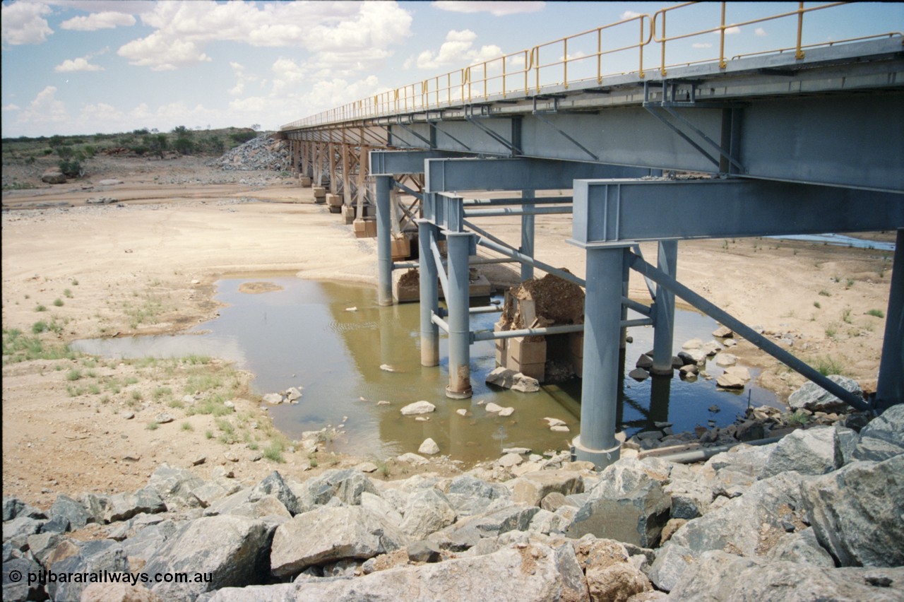 226-03
Yule River bridge showing new piles and deck to replace flood damaged piles after a cyclone that closed the line for two weeks in the late 1990s. [url=https://goo.gl/maps/G67Mat23u4P2]GeoData[/url].
