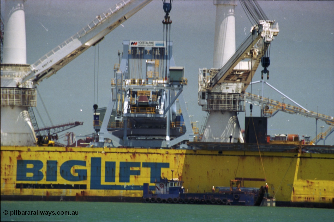 238-04
Port Hedland Harbour, heavy lift ship Happy Buccaneer (IMO: 8300389) sits at Finucane Island D Berth delivering a new shiploader for BHP Billiton. 1st November 2003. [url=https://goo.gl/maps/vWZoHTsRPsp] Geodata [/url]. Back in time here the ship cranes were only 550 tonne each, these are now 700.
Keywords: Happy-Buccaneer;Hitachi-Shipbuilding-Osaka-Japan;