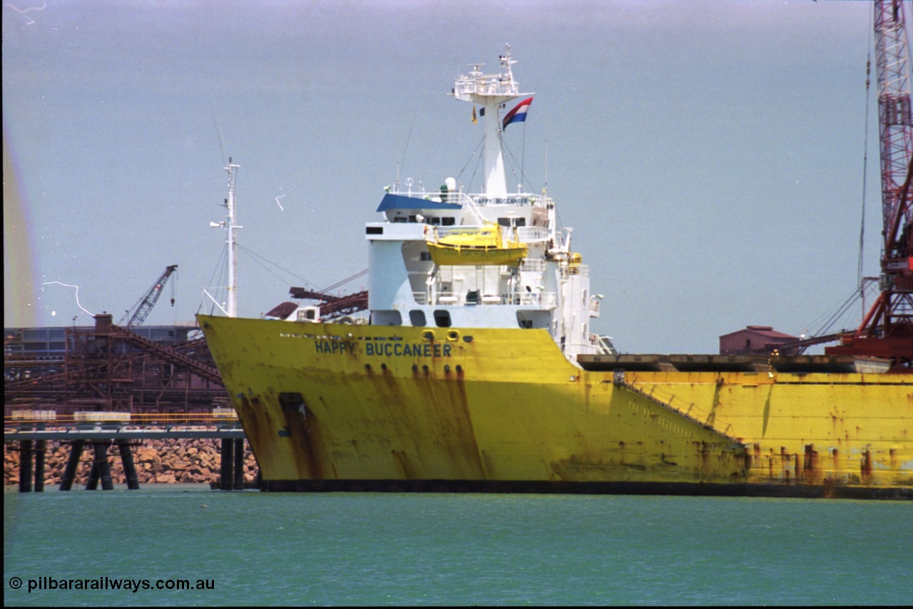 238-06
Port Hedland Harbour, heavy lift ship Happy Buccaneer (IMO: 8300389) sits at Finucane Island D Berth delivering a new shiploader for BHP Billiton. 1st November 2003. [url=https://goo.gl/maps/vWZoHTsRPsp] Geodata [/url]. Back in time here the ship cranes were only 550 tonne each, these are now 700.
Keywords: Happy-Buccaneer;Hitachi-Shipbuilding-Osaka-Japan;