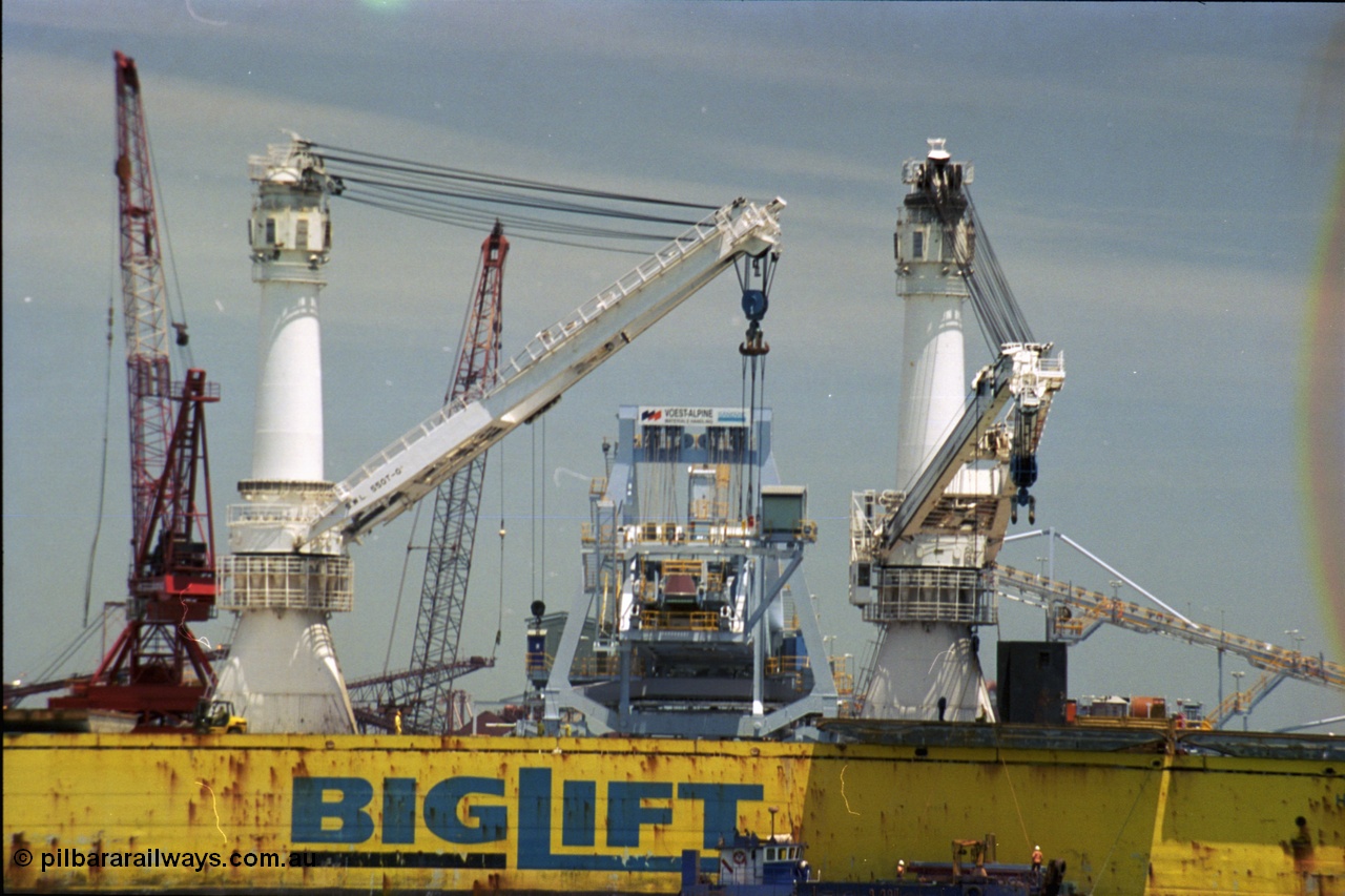 238-09
Port Hedland Harbour, heavy lift ship Happy Buccaneer (IMO: 8300389) sits at Finucane Island D Berth delivering a new shiploader for BHP Billiton. 1st November 2003. [url=https://goo.gl/maps/vWZoHTsRPsp] Geodata [/url]. Back in time here the ship cranes were only 550 tonne each, these are now 700.
Keywords: Happy-Buccaneer;Hitachi-Shipbuilding-Osaka-Japan;