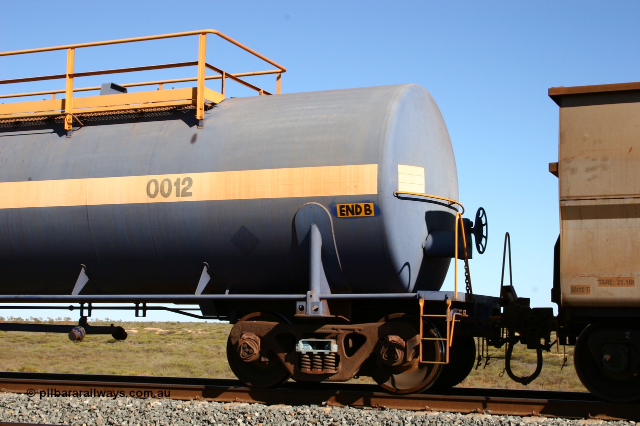 050704 3971
Bing Siding, empty 116 kL Comeng NSW built tank waggon 0012 from 1972, one of three such tank waggons, view of handbrake detail, on the rear of a loaded ore train.
Keywords: Comeng-NSW;BHP-tank-waggon;