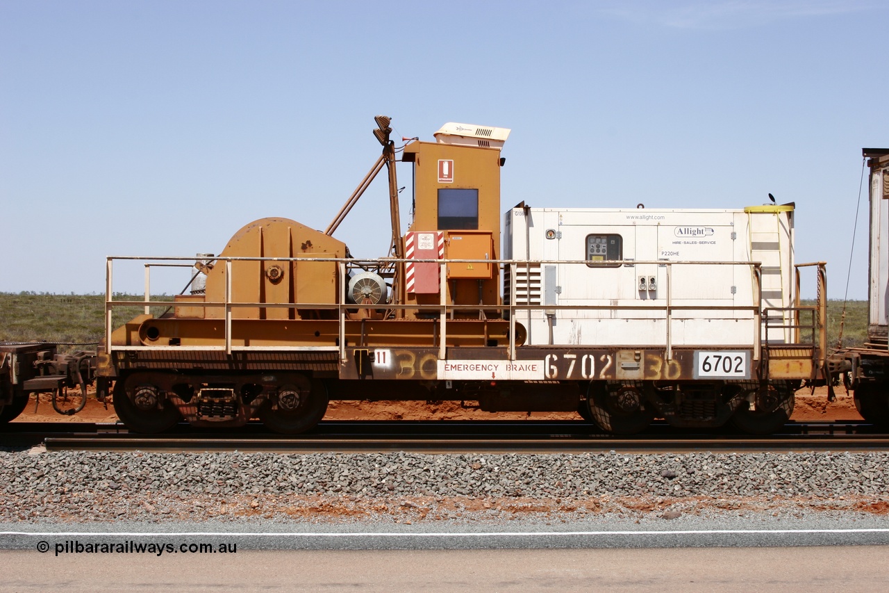 051001 5730
Boodarie, the Steel Train or rail recovery and transport train, flat waggon #30, 6702, heavily cut down and modified Magor USA ore waggon by Mt Newman Mining workshops, converted to a 50 tonne waggon and designated the winch waggon with generator set to power the winch and the crib car.
Keywords: Magor-USA;Mt-Newman-Mining-WS;BHP-rail-train;