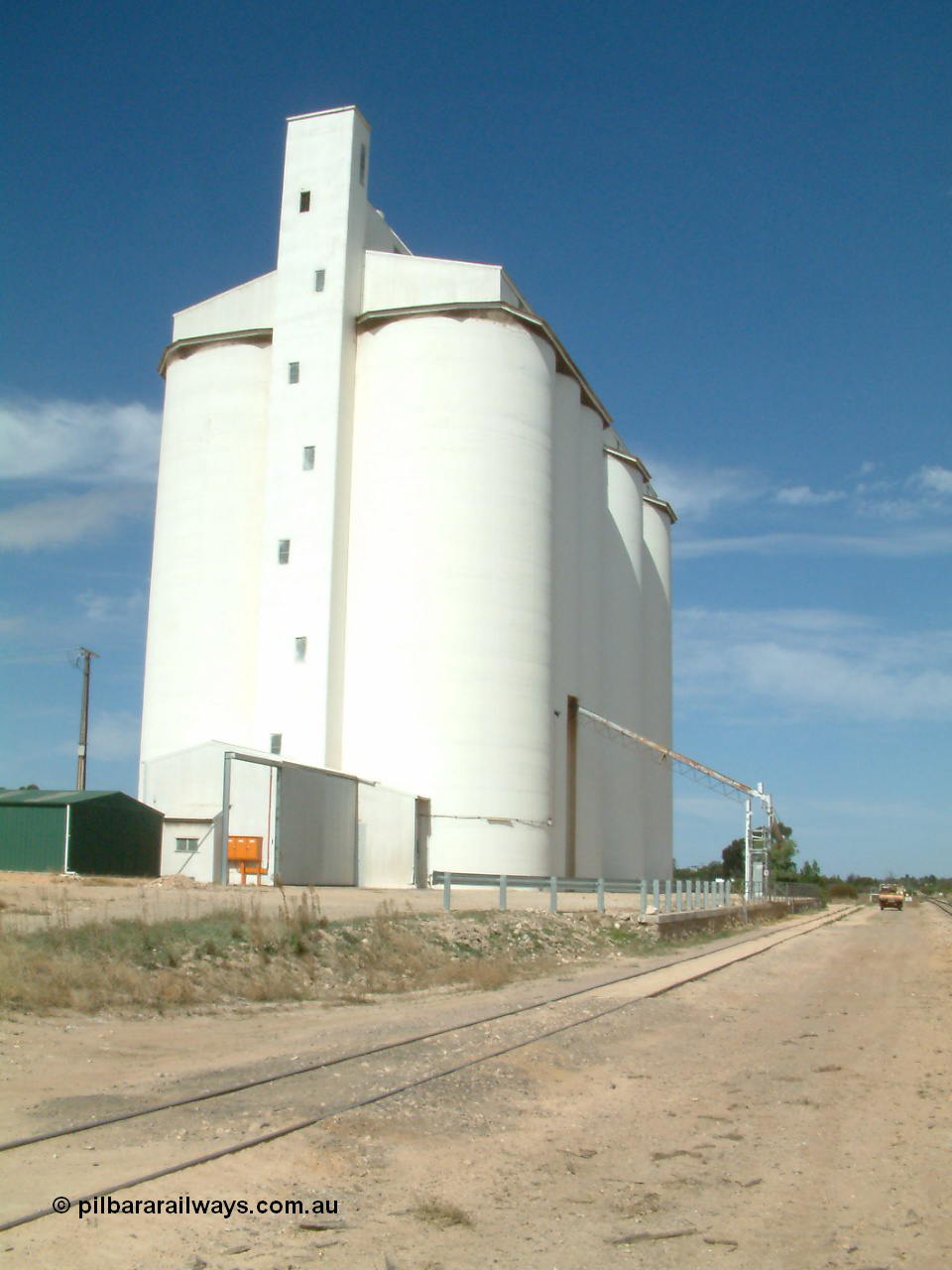 030405 140314
Kyancutta, yard view of concrete silo complex for SACBH and outflow spout, looking south, 5th April 2003.
