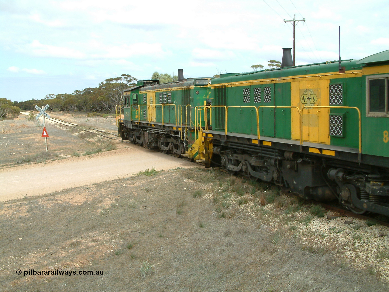 030409 115610
Darke Peake, at the 195 km Dog Fence Road grade crossing loaded grain train with 830 class unit 851 AE Goodwin ALCo model DL531 serial 84137, 851 has spent its entire operating career on the Eyre Peninsula, leads fellow 830 class 842 serial 84140 and a rebuilt unit DA 4, rebuilt from 830 class unit 839 by Port Augusta Workshops, retains original serial 83730 and model DL531 with the first twelve waggons behind the locos XNW type.
Keywords: 830-class;851;84137;AE-Goodwin;ALCo;DL531;