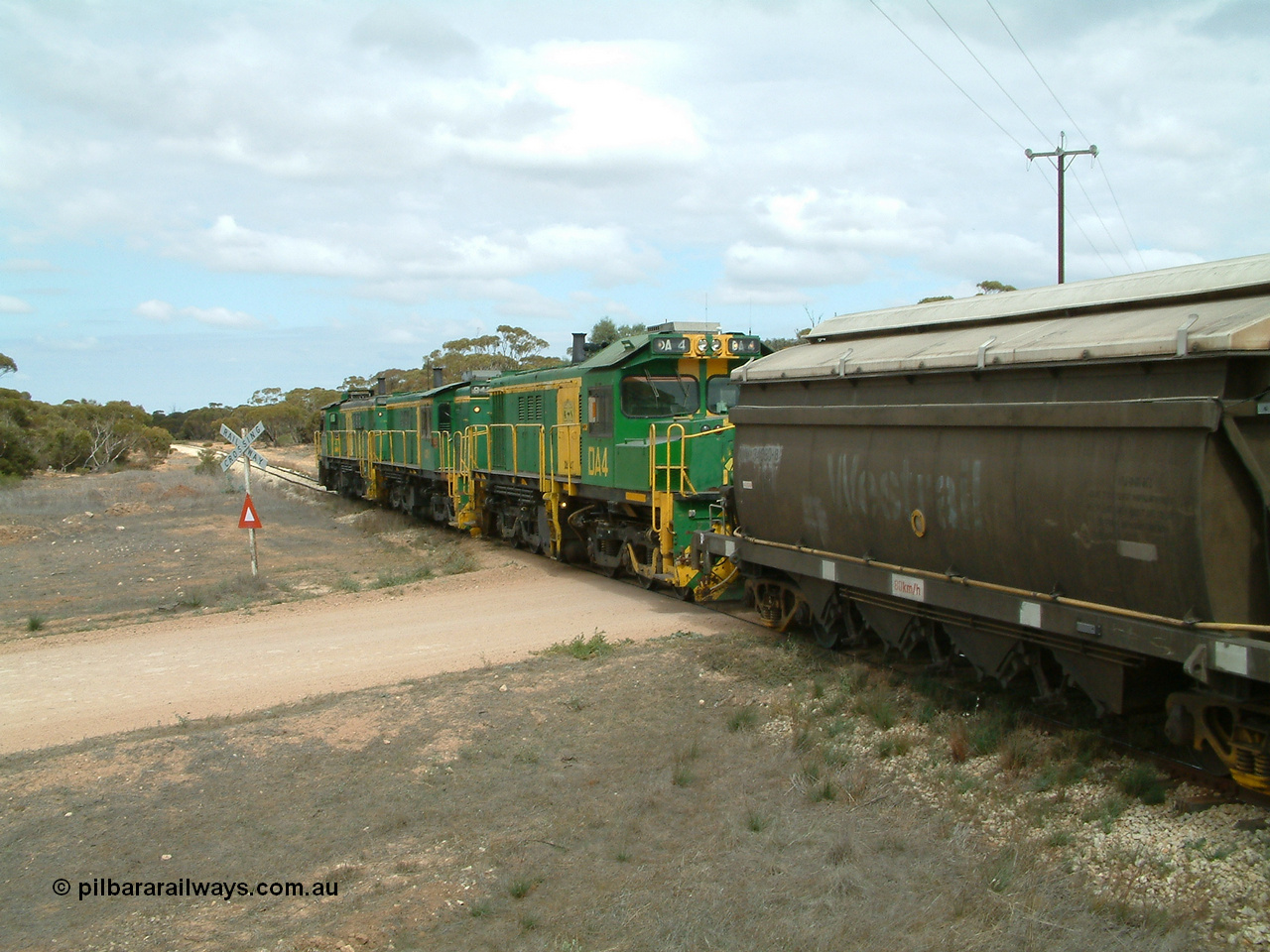 030409 115618
Darke Peake, at the 195 km Dog Fence Road grade crossing loaded grain train with 830 class unit 851 AE Goodwin ALCo model DL531 serial 84137, 851 has spent its entire operating career on the Eyre Peninsula, leads fellow 830 class 842 serial 84140 and a rebuilt unit DA 4, rebuilt from 830 class unit 839 by Port Augusta Workshops, retains original serial 83730 and model DL531 with the first twelve waggons behind the locos XNW type.
Keywords: DA-class;DA4;83730;Port-Augusta-WS;ALCo;DL531G/1;830-class;839;rebuild;