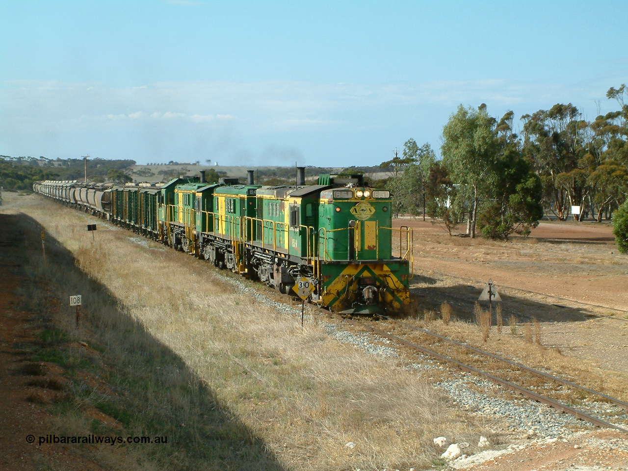 030409 152420
Ungarra, the peace is shattered as a loaded grain train storms upgrade through the station behind 830 class unit 851 AE Goodwin ALCo model DL531 serial 84137, fellow 830 class 842 serial 84140 and a rebuilt DA class unit DA 4.
Keywords: 830-class;851;84137;AE-Goodwin;ALCo;DL531;