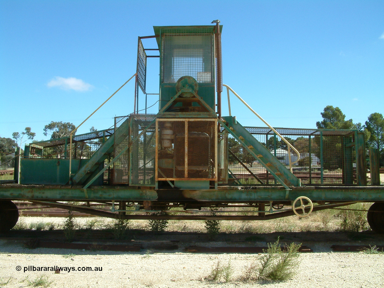 030411 110005
Kimba, rail recovery winch waggon EZWL 2, shows cabin mounted above motor, built using underframe of broad gauge horse box BH 4331. To Eyre Peninsula 1992, recoded then from AZWL. Scrapped in 2005.
Keywords: EZWL-type;EZWL2;SAR-Islington-WS;BH-type;BH4331;