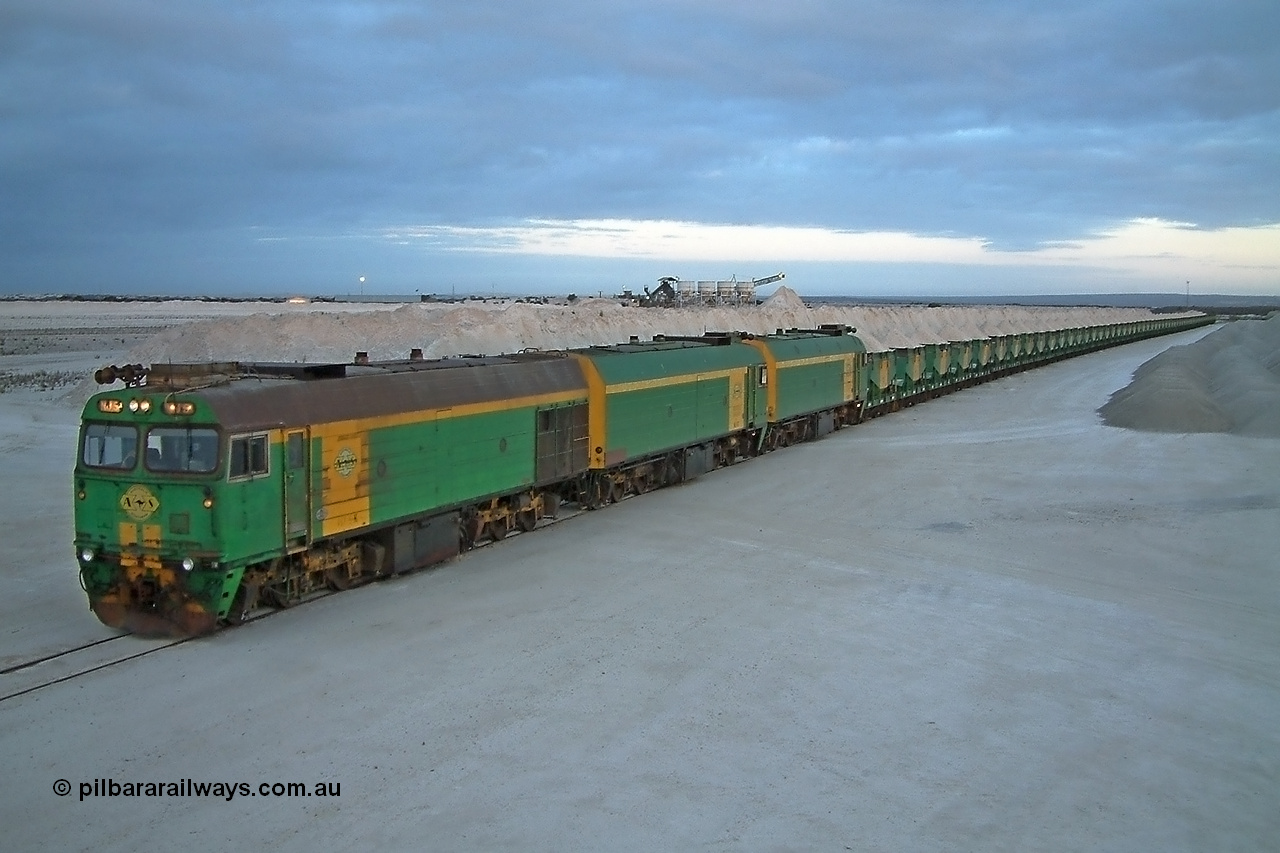 030415 070408
Kevin, loading is almost complete 0700 hrs. as gypsum train 3DD2 stands behind triple NJ class Clyde Engineering EMD JL22C model units serial 71-732, NJ 6 serial 71-733 and NJ 3 serial 71-730, these units built in 1971 at Clyde's Granville workshops started out on the Central Australia Railway for the Commonwealth Railways before being transferred to the Eyre Peninsula system in 1981. In the background are the old loading bins. At the [url=https://goo.gl/maps/fjUHW]Kevin loading point[/url].
Keywords: NJ-class;NJ5;Clyde-Engineering-Granville-NSW;EMD;JL22C;71-732;