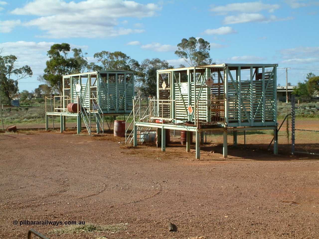 030415 160010
Tarcoola, at the 504.5 km, works compound see old livestock waggons converted to storage shed for gas bottles and the like. [url=https://goo.gl/maps/6oGe5dhUe3chHeB57]GeoData location[/url]. 15th April 2003.

