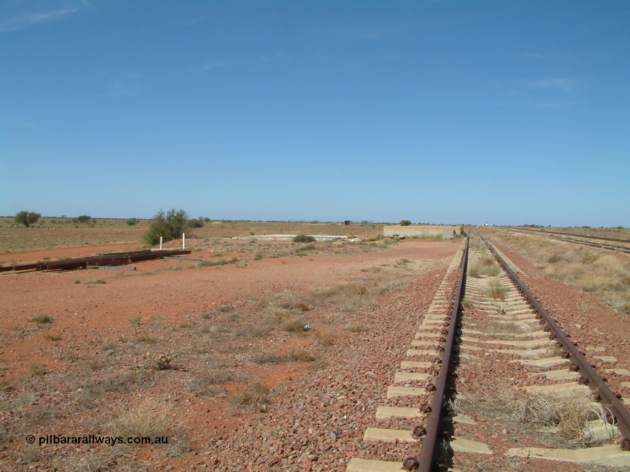 030416 110102
Manguri Siding, looking south along the third road or goods siding, loading platform, located 706.5 km from the 0 datum at Coonamia and 200 km north of Tarcoola between Wirrida and Cadney Park on the Tarcoola - Alice Springs line. [url=https://goo.gl/maps/y8coKnvDBraSuT8G7]GeoData location[/url]. 16th April 2003.
