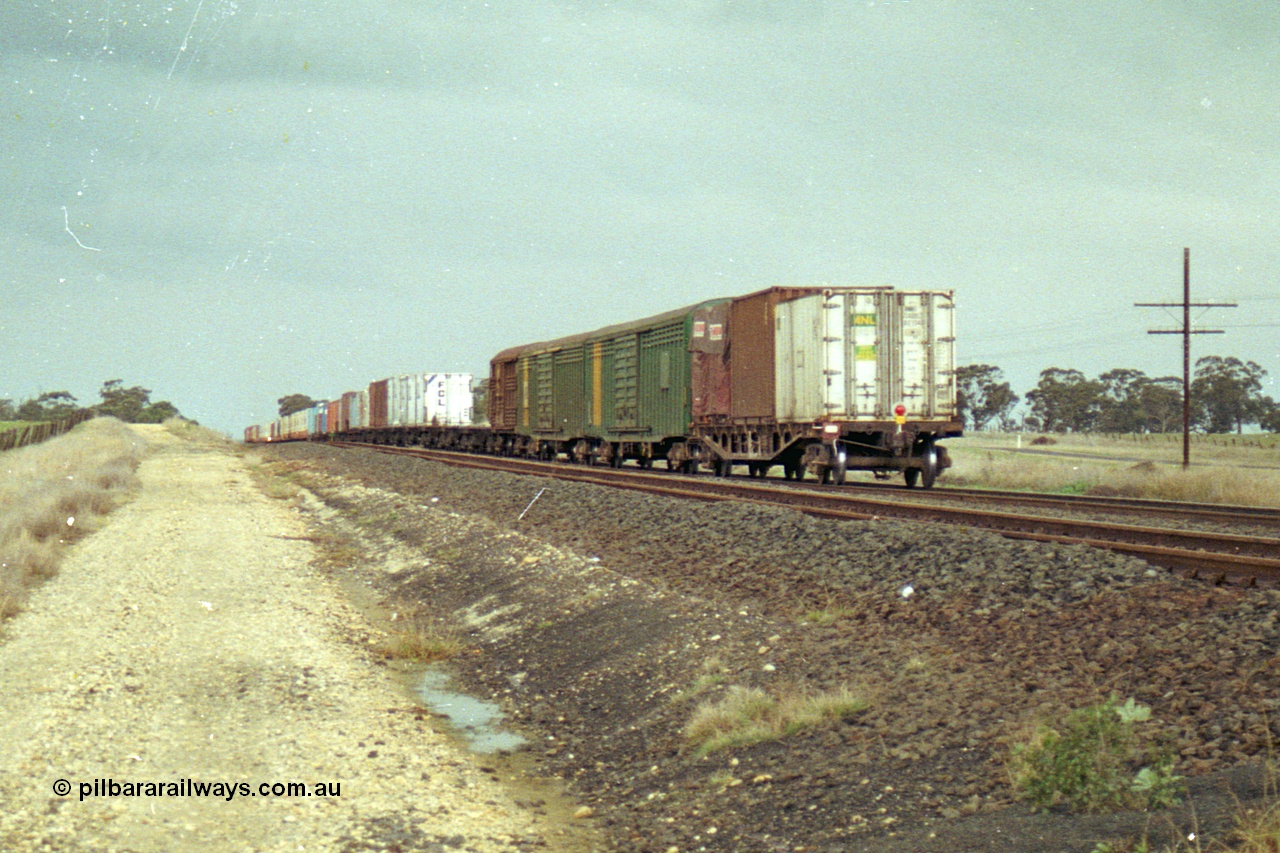 113-22
Parwan Loop, V/Line broad gauge train 9150, up Adelaide goods, in miserable conditions, poor quality, trailing shot.
