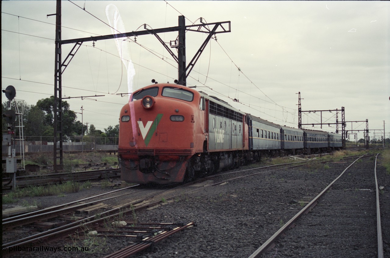 123-2-27
Sunshine V/Line broad gauge down Bacchus Marsh passenger train with aging B class B 64 Clyde Engineering EMD model ML2 serial ML2-5 and blue coach set consisting of South Australian K type carriages, AK 1 (500), BK 1 (702), BKL 3 (600) and BK 2 (703).
Keywords: B-class;B64;Clyde-Engineering-Granville-NSW;EMD;ML2;ML2-5;bulldog;