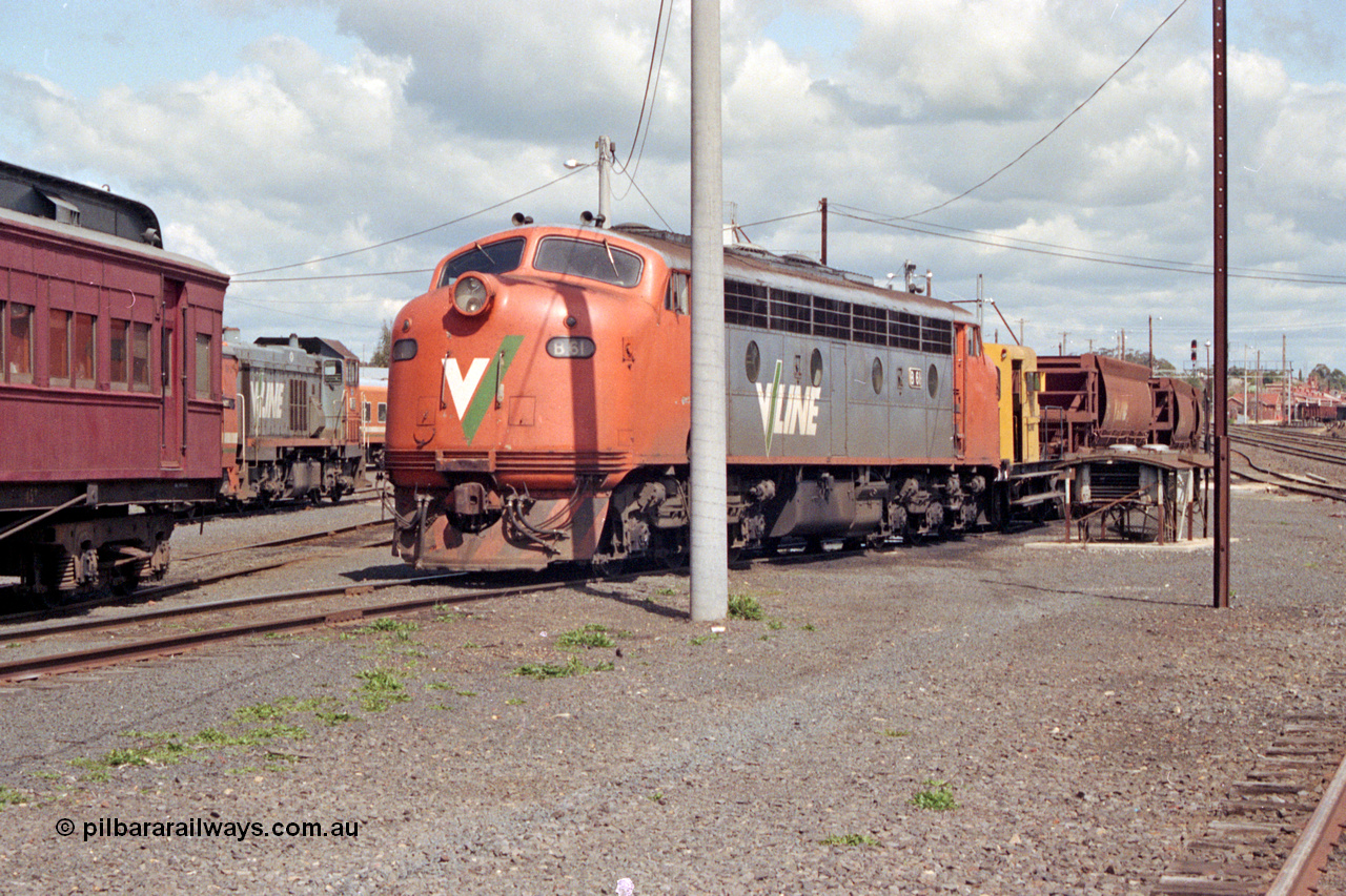127-04
Seymour loco depot, V/Line B class B 61 Clyde Engineering EMD model ML2 serial ML2-2, Rail Tractor RT class member RT 40 and ballast waggons in view.
Keywords: B-class;B61;Clyde-Engineering-Granville-NSW;EMD;ML2;ML2-2;bulldog;