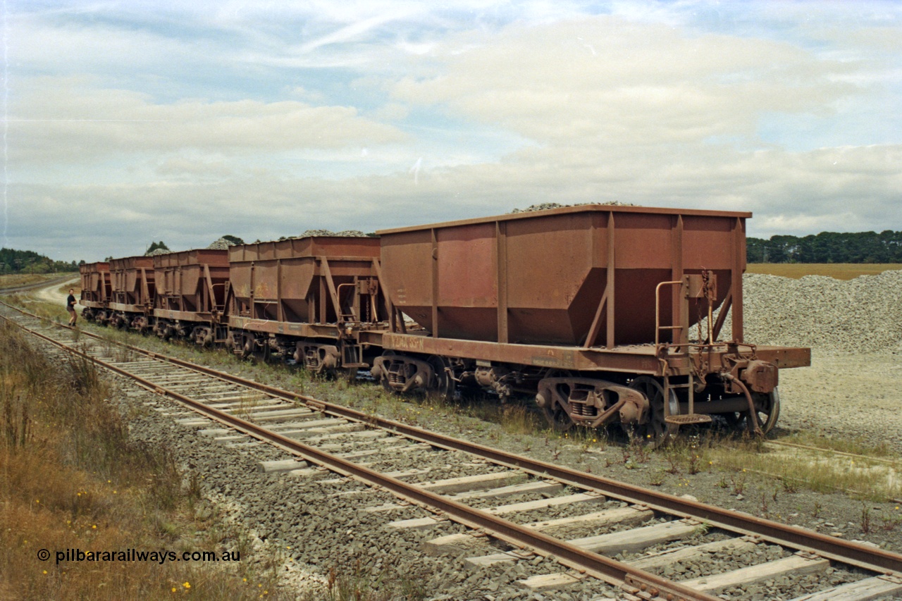 128-11
Ballarat, ballast loading site on the former Linton Line near Ring Road, five loaded V/Line broad gauge VZMA type bogie ballast waggons VZMA 85 and others. VZMA 85 was built at Newport Workshops in 09/1950 as an NN class bogie ballast hopper waggon, re-classed VHWA in 1979, 11/1983 at Bendigo got rebuilt body, 06/1998 re-classed to VZMA, also note is has a spoked wheel set in one bogie.
Keywords: VZMA-type;VZMA85;Victorian-Railways-Newport-WS;NN-type;VHWA-type;