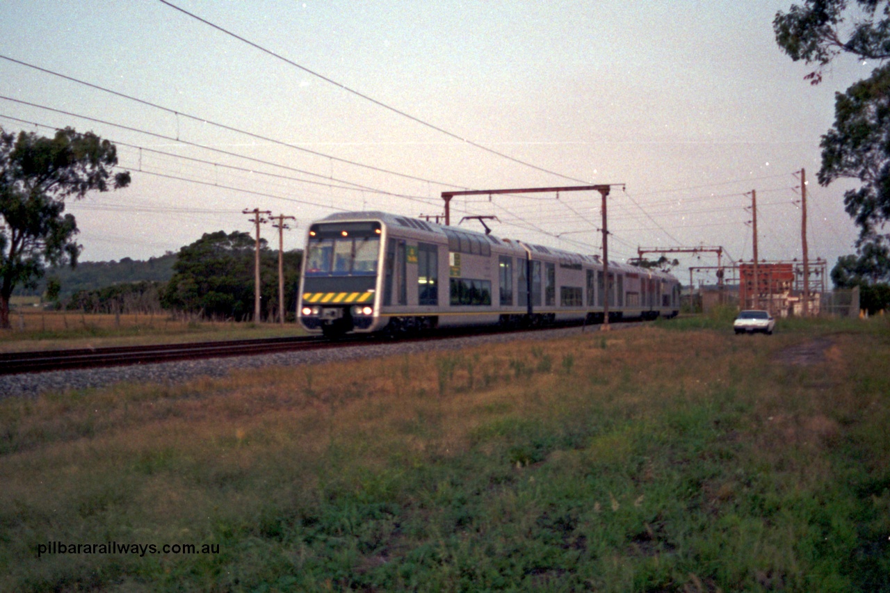 129-1-06
Nar Nar Goon - Tynong section, west of Tynong, 4D (Double Deck Development and Demonstration), double deck suburban electric set, testing phase. The set was built by Goninan NSW in December 1991 as a 'Tamgara' model.
Keywords: 4D;Double-Deck-Development-Demonstration-train;Goninan-NSW;Tangara;