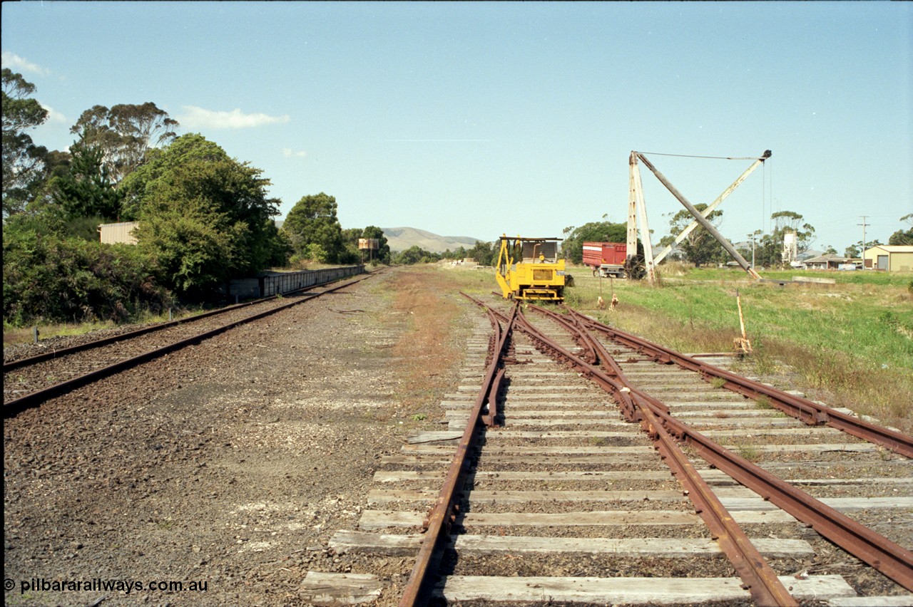 129-3-03
Foster yard overview, Melbourne end looking towards Toora, sleeper inserting machine, timber derrick crane, tracks removed, double compound points and levers.
