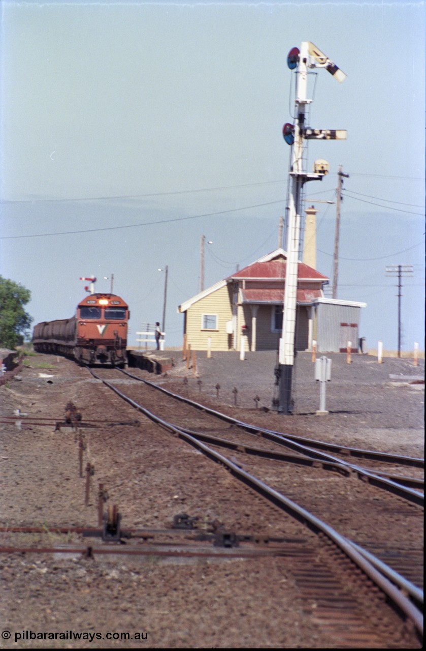 133-32
Gheringhap station yard overview, looking from Ballarat line points towards Geelong, semaphore signal post 4 pulled off for Cressy line, points, point rodding, signal wires and interlocking, V/Line broad gauge grain train 9123 swapping electric staff for train order for Maroona, safeworking.
Keywords: G-class;G533;Clyde-Engineering-Somerton-Victoria;EMD;JT26C-2SS;88-1263;