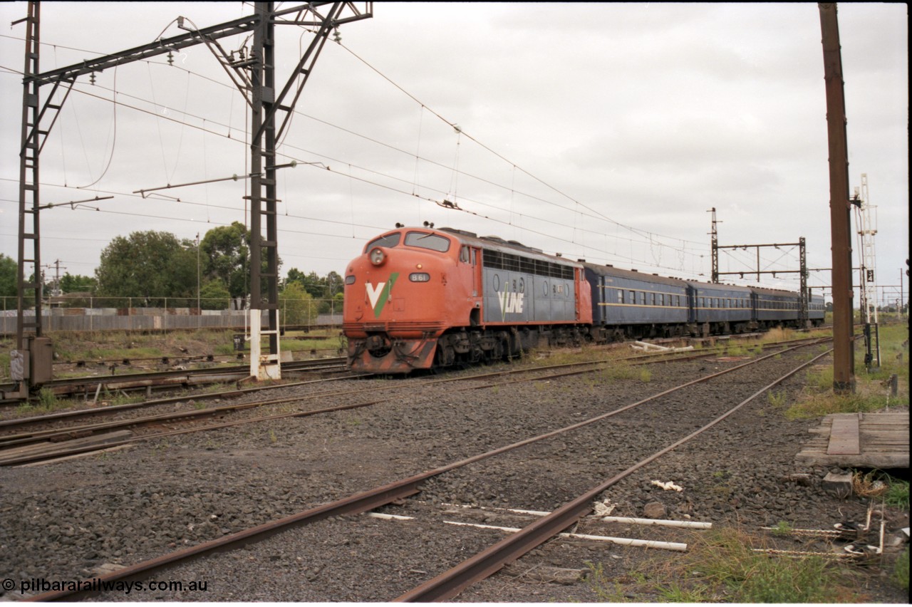 141-1-16
Sunshine, broad gauge V/Line B class B 61 Clyde Engineering EMD model ML2 serial ML2-2 leads the blue rake of South Australian K type carriages, AK 1 (500), BK 1 (702), BKL 3 (600) and BK 2 (703), on a down Bacchus Marsh passenger train heading into platform 3.
Keywords: B-class;B61;Clyde-Engineering-Granville-NSW;EMD;ML2;ML2-2;bulldog;