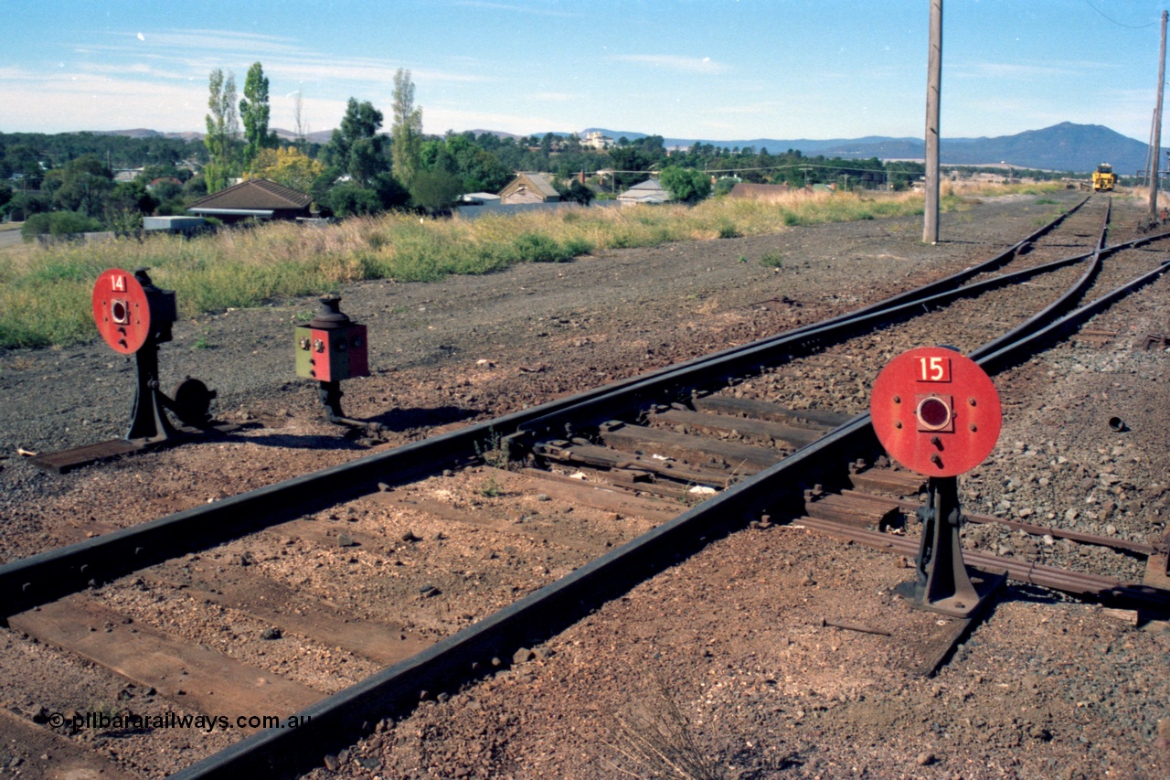 153-2-30
Ararat station yard, ground dwarf disc signals 14 from 9-16 Rds New Goods Yard, and 15 from 8 Rd New Goods Yard, with a point indicator.
