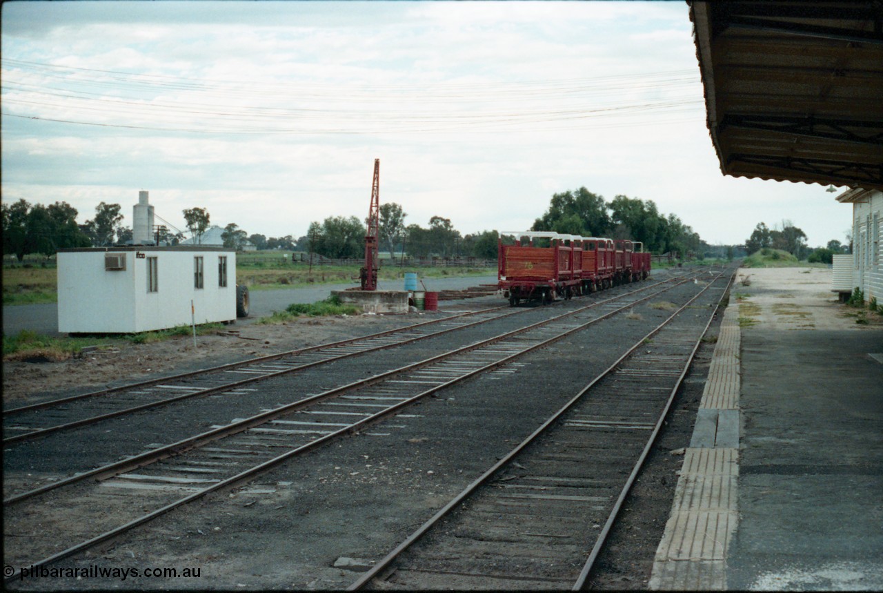 161-24
Tocumwal, broad gauge yard overview from station platform with sleeper transport waggons, stock yards and grain silo complex in the background.
