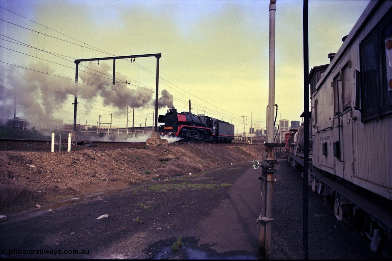 162-3-17
Melbourne Yard, Steamrail R class R 761 North British Locomotive Company, Glasgow, Scotland model Hudson serial 27051 reverses back to Spencer Street having run around the reversing loop, stabled Weedex train at right edge of frame.
Keywords: R-class;R761;North-British-Locomotive-Company;Hudson;27051;