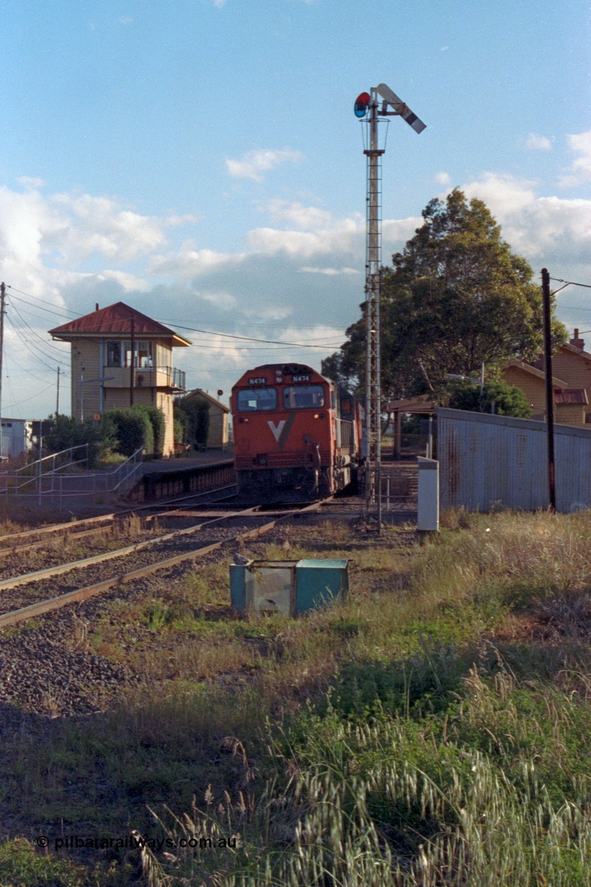 167-01
Wallan, down broad gauge Seymour passenger train hauled by V/Line N class N 474 'City of Traralgon' Clyde Engineering EMD model JT22HC-2 serial 87-1203, gangers trolley shed at right, semaphore signal post 4 pulled off, station building behind and elevated signal box on platform two and waiting room at left.
Keywords: N-class;N474;Clyde-Engineering-Somerton-Victoria;EMD;JT22HC-2;87-1203;