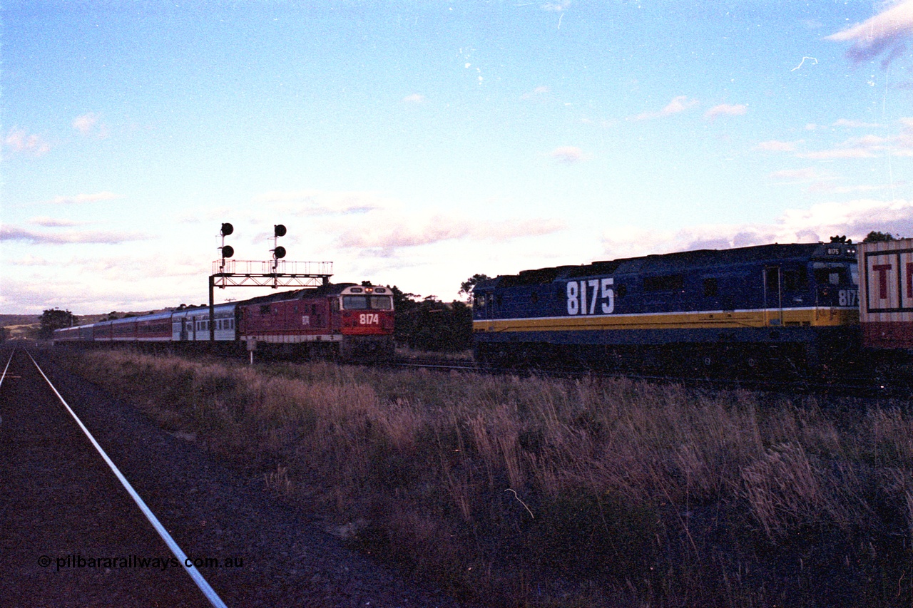 167-09
Wallan Loop, north end, standard gauge NSWSRA 81 class sisters cross each other, 8174 Clyde Engineering EMD model JT26C-2SS serial 85-1093 in candy livery leads the south bound Inter-Capital Daylight, while 8175 Clyde Engineering EMD model JT26C-2SS serial 85-1094 in new Freight Rail 'Stealth' livery sits on the loop with a north bound goods.
Keywords: 81-class;8175;Clyde-Engineering-Kelso-NSW;EMD;JT26C-2SS;85-1094;8174;85-1093;