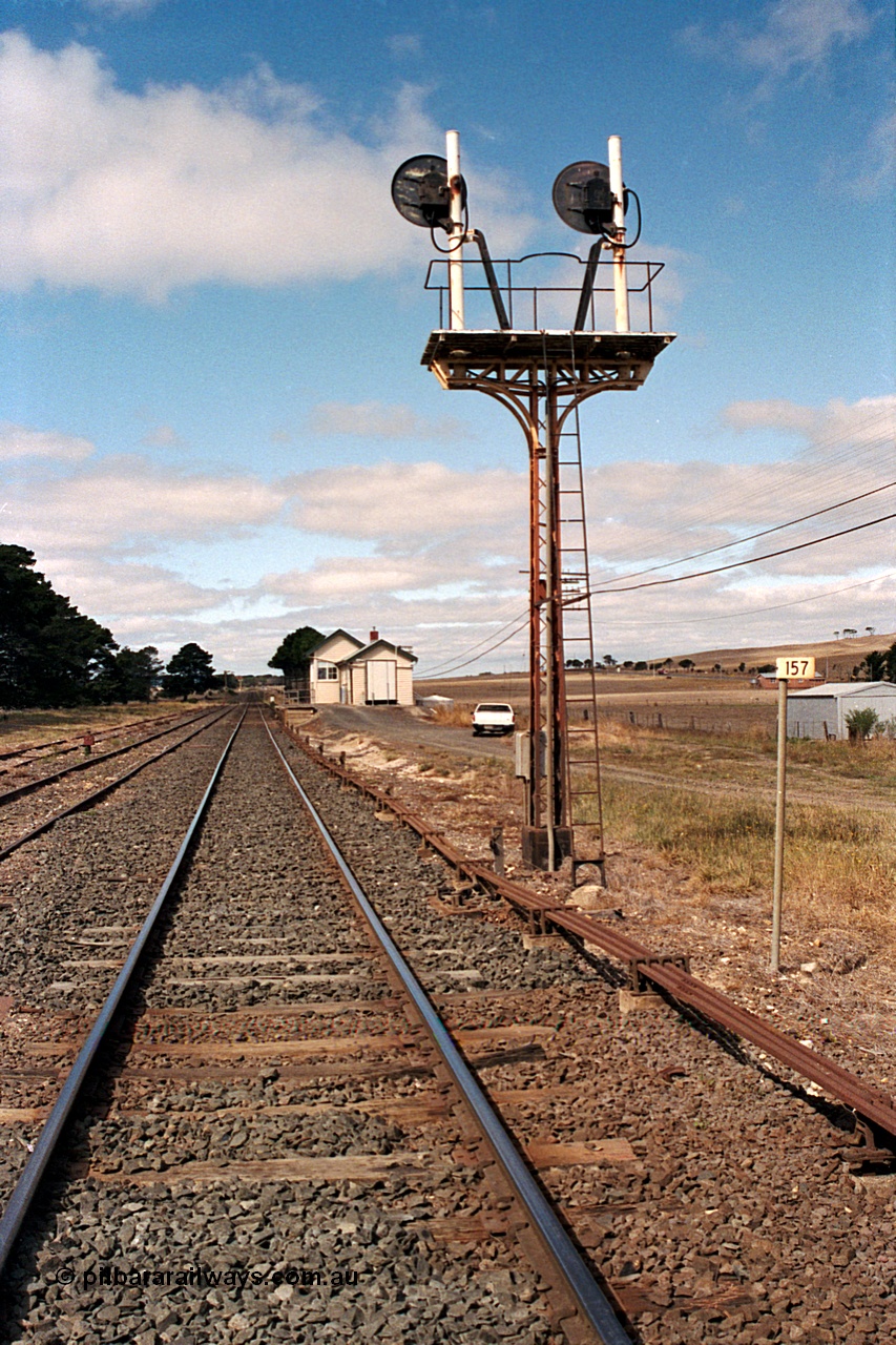 171-08
Trawalla station yard overview, looking towards Melbourne down main line, 157 km post, searchlight signal Post 5, point rodding, station building.
