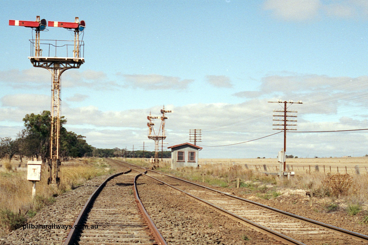 171-11
Trawalla station yard overview, looking towards Melbourne down the end of No.2 Road, semaphore Signal Post 3 left arm Home for No. 2A Road to Main Line and right arm Home for No.1 Road to Main Line, telephone cabinet facing camera, semaphore signal Post 2 facing down trains, with electric interlocking room for motorised point machine.
