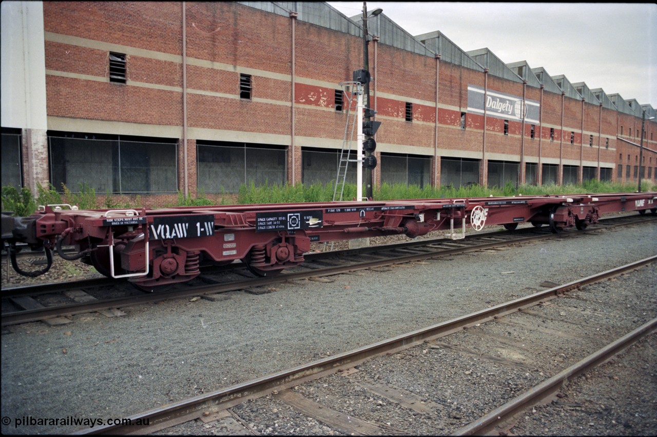 174-18
Albury, V/Line standard gauge VQAW type leader VQAW 1, three pack articulated container waggon with Gloucester bogies, built new at Ballarat North Workshops and issued to traffic 22-11-1990, empty on a south bound goods train, the disused Dalgety's warehouse is behind the waggon.
Keywords: VQAW-type;VQAW1;V/Line-Ballarat-Nth-WS;