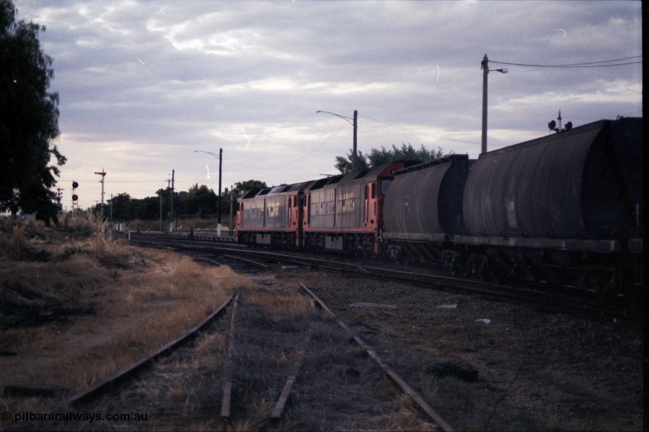 176-23
Wodonga, a pair of V/Line standard gauge G class units, lead by G 520 Clyde Engineering EMD model JT26C-2SS serial 85-1233 power an up goods train bound for Melbourne, the rails in the foreground are the former broad gauge Cattle Sidings 4 and 5 and the Amoco Siding, the standard gauge Cattle Siding track is visible running to the left off the mainline, the semaphore signals are for the broad gauge yard and the colour search light signal post for the standard gauge Wodonga Loop.
