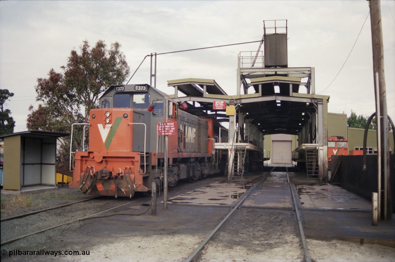 178-19
Ballarat East loco depot fuel and sanding point, V/Line broad gauge T class T 373 Clyde Engineering EMD model G8B serial 64-328 stabled over the weekend coupled to an X class, an N class lurks in the background.
Keywords: T373;Clyde-Engineering-Granville-NSW;EMD;G8B;64-328;