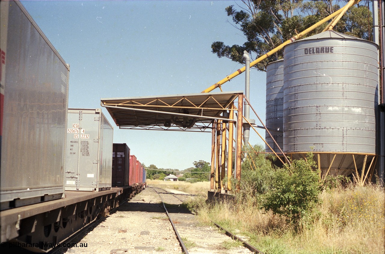 182-02
Wahgunyah, Delarue silo complex located on former station platform, looking north to wards terminus, rake of bogie container waggons for Uncle Tobys at left.
