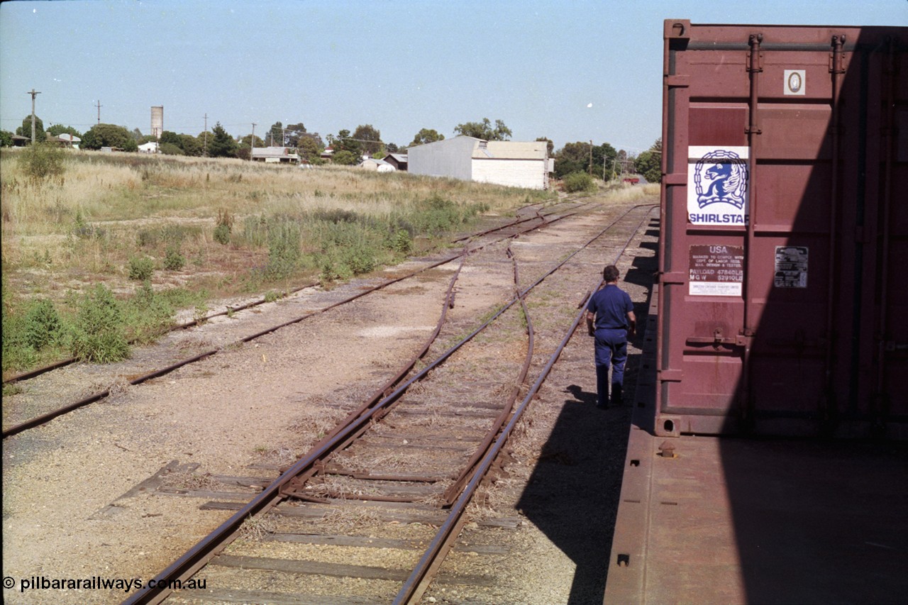 182-09
Wahgunyah, yard view looking towards terminus, crossover points from No.3 Road to 4 have been spiked and levers have been removed, bogie container waggons for Uncle Tobys are on No.2 Road.
