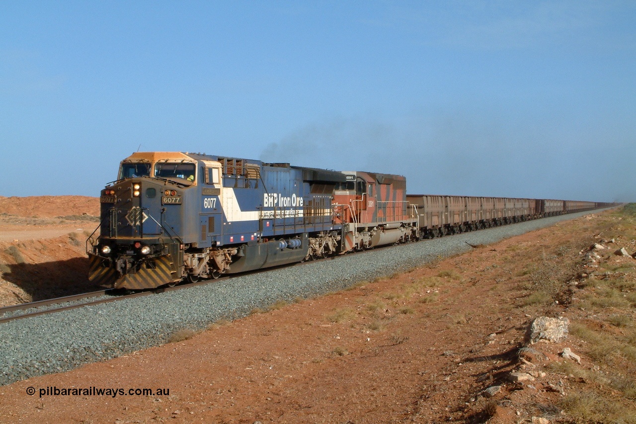050204 080056r
Mooka, BHP GE AC6000 final unit 6077 serial 51069 with EMD SD40R 3091 serial 31496 originally Southern Pacific SD40 SP 8415 power along at the 30 km mark with an empty 200 waggon train, smoke can just been seen coming from mid train units 6071 and 3083 4th February 2005.
Keywords: 6077;GE;AC6000;51069;
