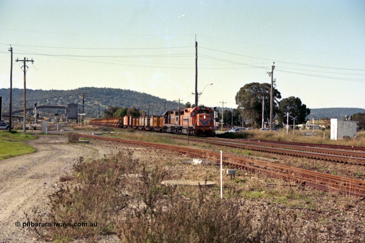 186-01
Midland, Westrail standard gauge up Kalgoorlie loaded acid train 428 crosses Lloyd Street behind a pair of L class locomotives L 263 Clyde Engineering EMD model GT26C, serial 68-553 and L 274 serial 73-779, with the dual gauge track to the Flashbutt Yard in the foreground. The empty return working of this train was 027 empty acid.
Keywords: L-class;L263;Clyde-Engineering-Granville-NSW;EMD;GT26C;68-553;