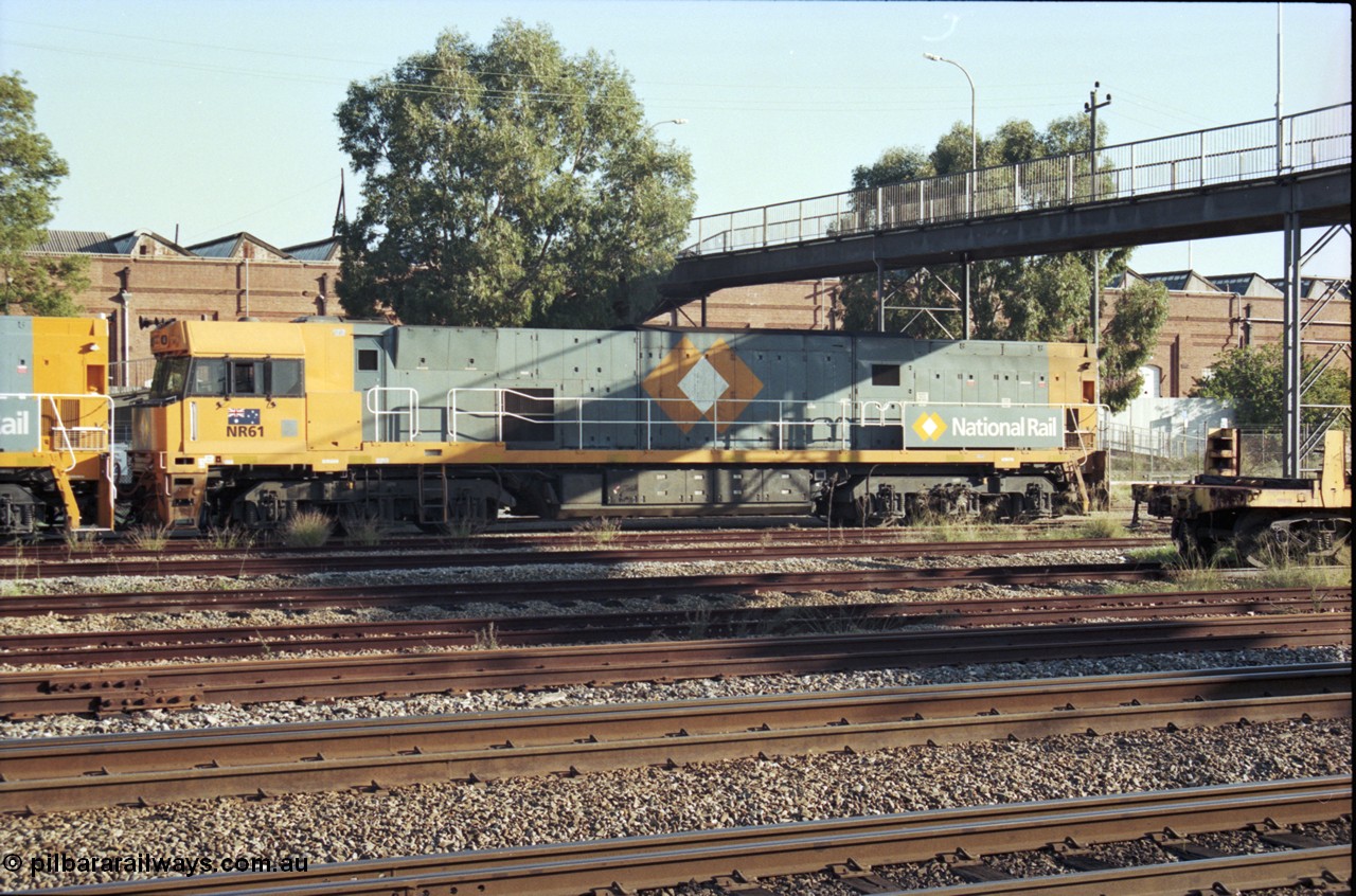 186-29
Midland, standard gauge yard, under the Midland Workshops footbridge, the first completed and built in Bassendean National Rail NR class NR 61 Goninan GE model Cv40-9i serial 7250-11/96-263 trails new sisters NR 101 and NR 102 as they perform their shunt movement.
Keywords: NR-class;NR61;Goninan;GE;Cv40-9i;7250-11/96-263;