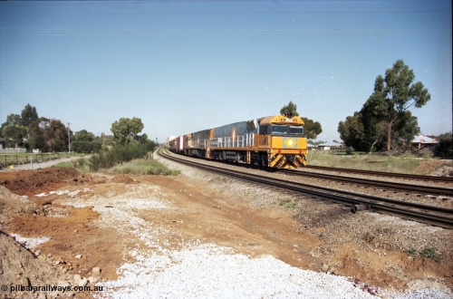 186-21
Woodbridge, a very clean and new looking NR class NR 100, a Goninan built GE model Cv40-9i serial 7250-07/97-304 leads a sister unit with National Rail intermodal train 4MP5 at Woodbridge Rd grade crossing.
Keywords: NR-class;NR100;Goninan;GE;Cv40-9i;7250-07/97-304;