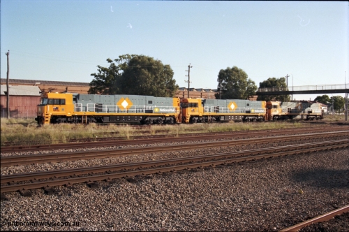 186-27
Midland, standard gauge yard, brand new Perth built National Rail NR class units NR 102 Goninan built GE model Cv40-9i serial 7250-07/97-302 and NR 101 serial 7250-07/97-303 shunt into the yard with the first Perth built sister NR 61 serial 7250-11/96-263.
Keywords: NR-class;NR102;Goninan;GE;Cv40-9i;7250-07/97-302;