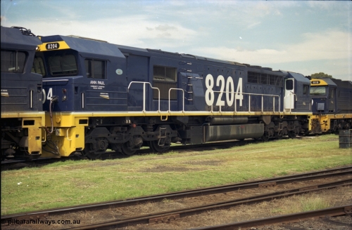 187-25
Yeerongpilly, NSWSRA standard gauge loco depot, 82 class Clyde Engineering built EMD model JT42C unit 8204 'Ann Paul - Wagga Wagga' serial 94-1311. [url=https://goo.gl/maps/MTvf4SEKLkJ2]GeoData[/url].
Keywords: 82-class;8204;Clyde-Engineering-Braemar-NSW;EMD;JT42C;94-1311;