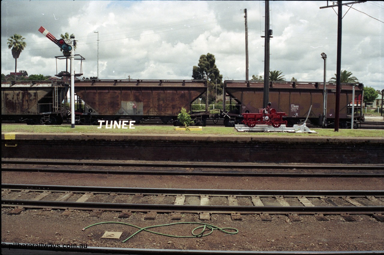 188-22
Junee station on the NSW Main South line, 485 km from Sydney, opened in July 1878, view across to the Up Platform from the Down Platform with NGMA grain waggons in No 2 Up Siding.
