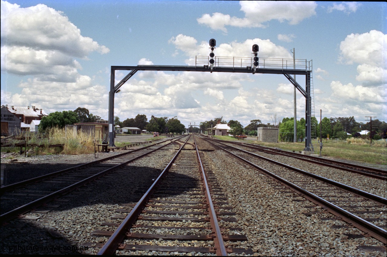 189-08
The Rock, located at the 550.29 km on NSW Main South line, view looking north with the along the Up Loop with the Up Siding at left, Mainline on the right and the Down Loop at far right, ground frame C is just in front of the signal bridge, loading crane and inspection car can be seen opposite the station.

