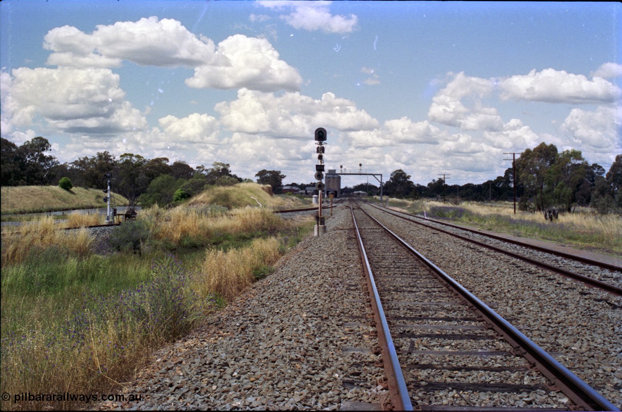 189-10
The Rock, located at the 550.29 km on NSW Main South line, view looking north with the along the Mainline with the Down Loop at right and the branch line to Oaklands coming in on the left with the ground frame E and signal, the No. 54 points from the Mainline to Up Loop are visible in front of the signal bridge.

