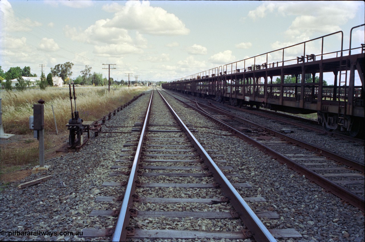 189-17
Yerong Creek, located at the 565.08 km on the NSW Main South line, view looking south along the mainline, then the Loop and Goods Siding with stored car carrying waggons, ground frame C and the points from the loop to siding.
