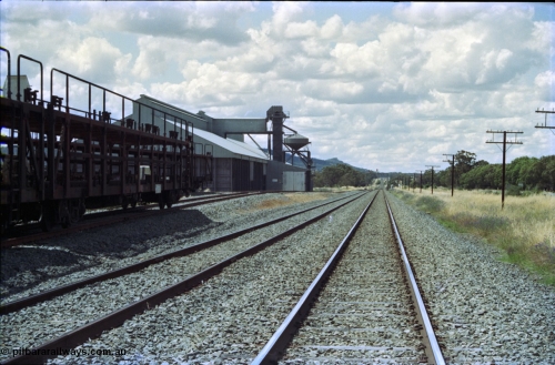 189-16
Yerong Creek, located at the 565.08 km on the NSW Main South line, view looking north along the mainline, then the Loop and Goods Siding with stored car carrying waggons.
