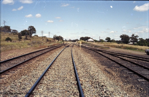 190-26
Bethungra, located at the 456.04 km on the NSW Main South line, looking south along the Up Main through the former station location with ground frame B for the trailing crossover visible on the left and the goods yard on the right.
